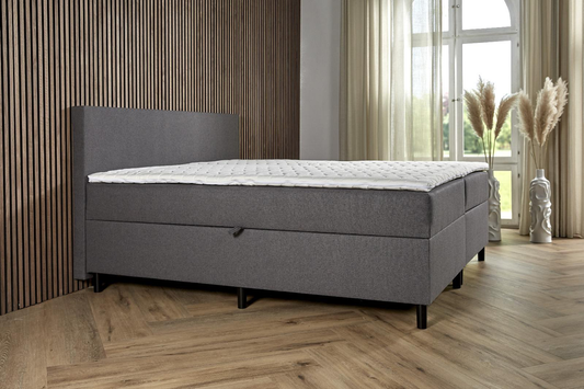 BSD Storage opbergboxspring in antraciet, schuin vooraanzicht met matras en witte topper [antraciet]